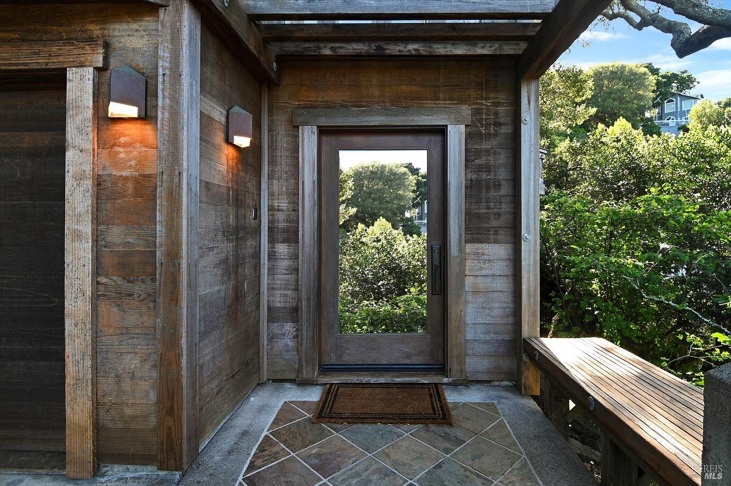Reclaimed wood entry portico with original Callister structural framing and slate floor