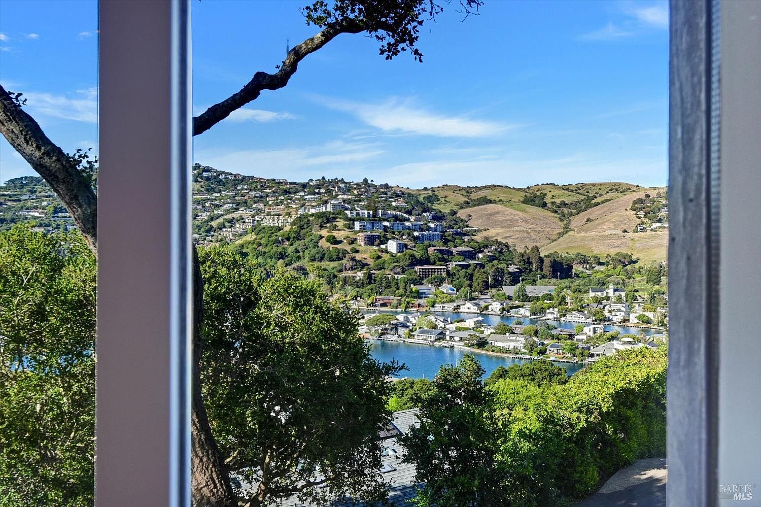 View through interior window framing onto Belvedere lagoon and Tiburon hillside